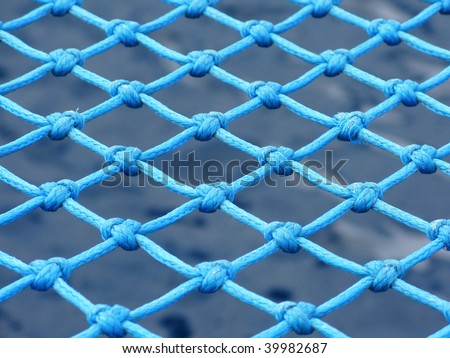 View through the safety net at the blue sea background
