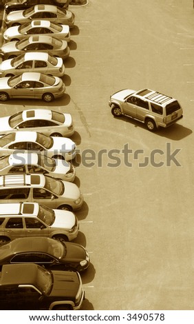 one more parking space left in a crowded stuffed lot of cars in the urban city setting