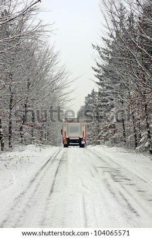 Truck driving in the snow in the countryside from the Netherlands