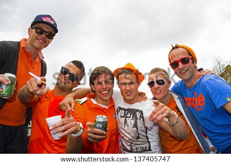 AMSTERDAM, NETHERLANDS - APRIL 30: People in orange celebrating in Amsterdam during the coronation of the new king Willem Alexander from the Netherlands on 30 april 2013