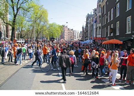 AMSTERDAM - APRIL 30: Big crowds in orange from people partying at the celebration of queensday on April 30, 2012 in Amsterdam, The Netherlands