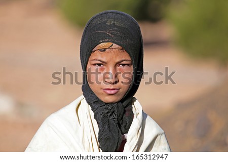 SAHARA DESERT, MOROCCO 19 OCTOBER 2013: Young nomad woman in the Sahara desert, Morocco. Nomadic tribes living in the desert with a traditional lifestyle as a hundred years ago.