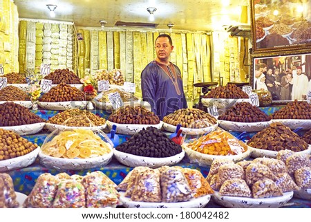 FES, MAROCCO - October 17 2013 : Merchant is selling dried fruits and nuts in the medina from Fes on October 17, 2013