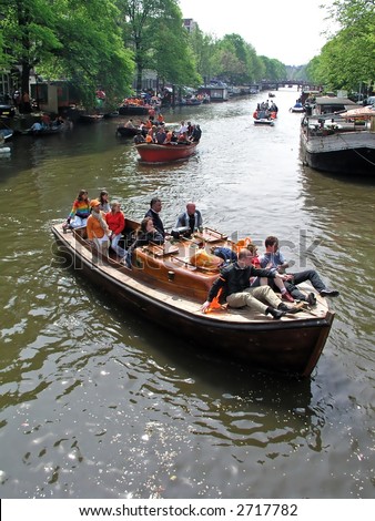 Cruising at queensday through Amsterdam canals in Holland