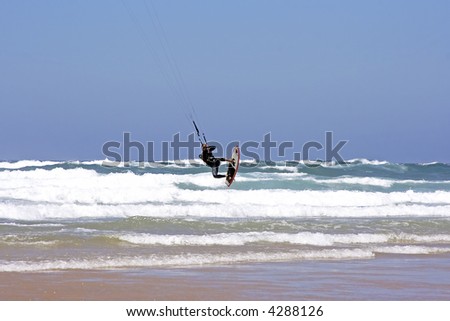 Kite surfer jumping at the atlantic ocean in Portugal
