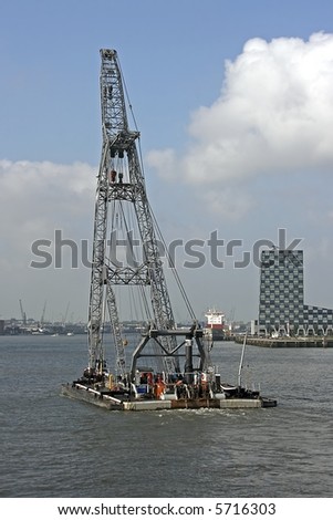 Hoisting crane on a tug boat in Rotterdam harbor in the Netherlands