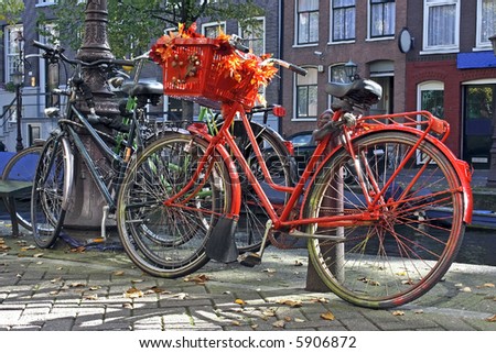 Orange bike designed with fall colours in the streets of Amsterdam the Netherlands