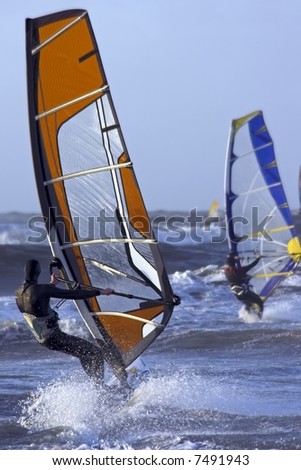 Windsurfers at the north sea in the Netherlands surfing