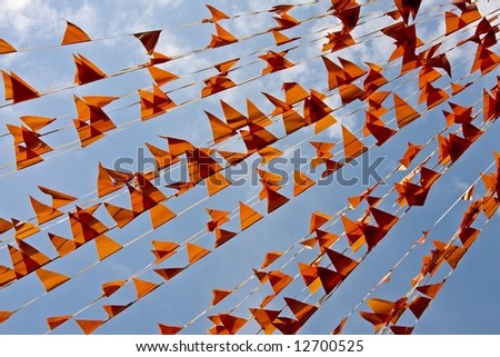 Little orange flags against a blue sky