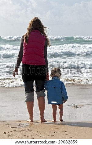 Mother and son watching the ocean