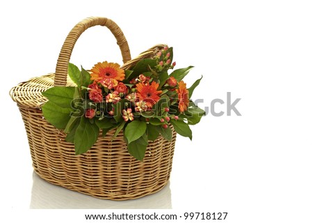 a bouquet of flowers in a wicker basket on a white background