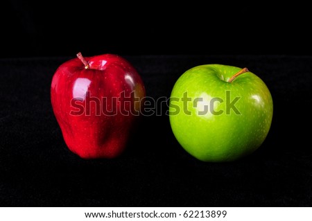 Two apples, red and green, isolated on a black background