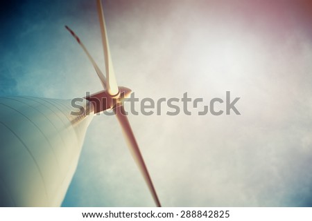 Wind turbine against deep blue sky -