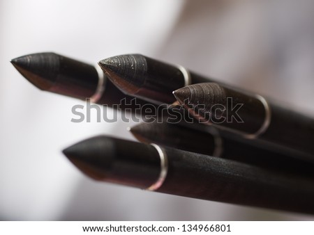 The front arrow heads of standard compound archery bow arrows. Shallow Depth of field