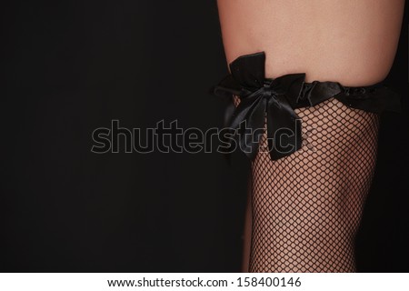 Fishnet stocking on a beautiful young adult caucasian full figured woman