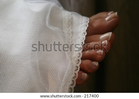 bare feet in a wedding dress