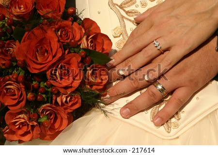 Wedding rings and rose bouquet
