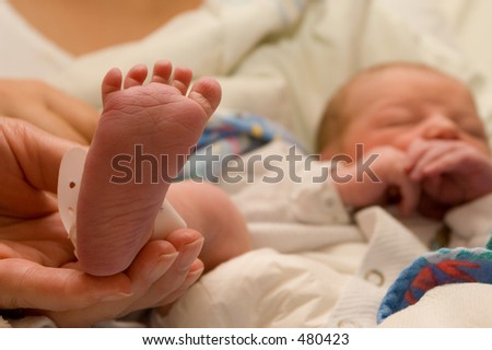 Foot of a new born baby - foot in focus, Face out of focus