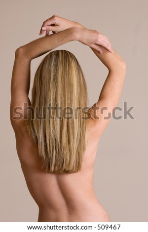 Naked blonde woman from behind - arms lifted