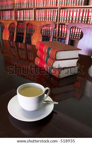 White Coffee cup with Legal Library in background and books on the table