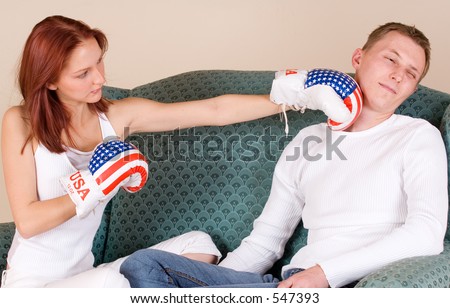 Woman hitting her boyfriend with boxing gloves