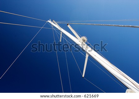 White Yacht sail and radio mast with rolled sails