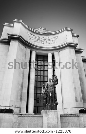 A statue in front of a old building in Paris, France. Black and white.   Copy space.