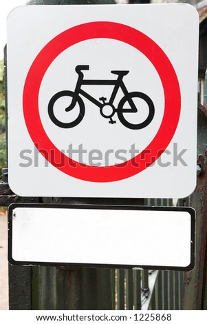 Sign  with a bicycle in a park. Copy space.