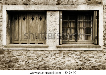 Windows of a house in Antibes, France.  Black and white - sepia tone. Copy space.