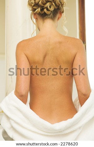 stock photo Woman undressing in a bathroom bathrobe over buttocks