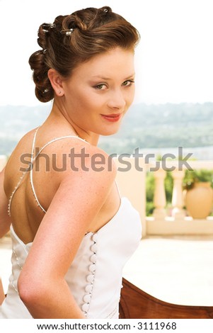 stock photo Young beautiful brunette bride with champagne colored wedding