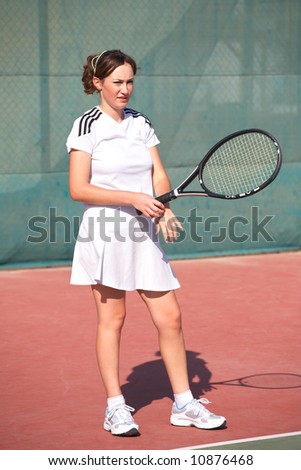 Young woman playing tennis in the sun
