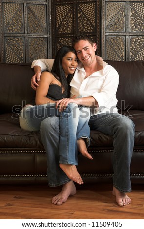 Loving couple on a brown leather couch