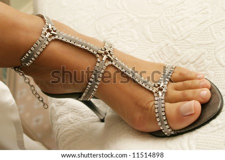Close-up of bridal shoes with crystal necklace.  Shallow D.O.F