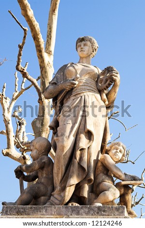 Old weathered statues on the old town square and marketplace in Aix-En-Provence, France. Outlined against a blue sky on a bright winter day