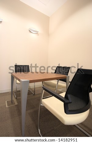 Empty small boardroom with new modern office furniture, including desks and chairs. HDR type image