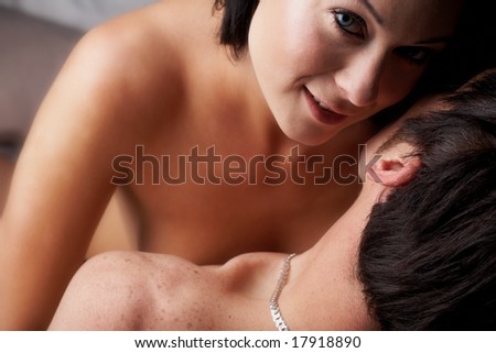 Young adult Caucasian couple in passionate embrace. The woman is wearing blue contact lenses