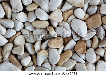 Light grey and brown smooth river pebble background textured