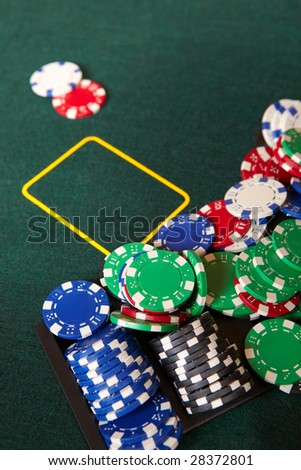 Chips and gambling around a green felt poker table. Shallow Depth of field