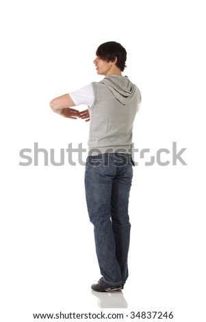 Single Caucasian male tap dancer wearing jeans showing various steps in studio with white background and reflective floor. Not isolated
