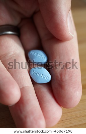 KUSADASI, TURKEY - JANUARY 20: Viagra pills presented in a man\'s hand on January 20, 2010 in Kusadasi, Turkey. Viagra was originally developed by Pfizer as an erectile dysfunction drug.