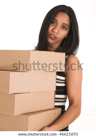 Young adult African-Indian businesswoman in casual office outfit carrying brown cardboard boxes on a white background. Not Isolated