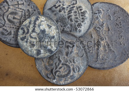 Antique ancient Greco-Roman coins from Turkey, on a smooth leather sheet.