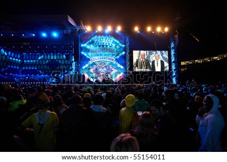 SOWETO - JUNE 10: Fans watch the opening speech of FIFA President Joseph Blatter and South African President Jacob Zuma for the FIFA World Cup Kick Off Celebration Concert on June 10, 2010 in Soweto