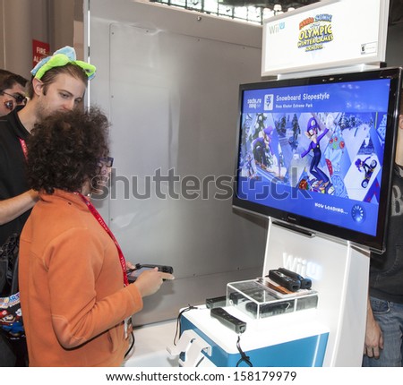 NEW YORK - October 13: Fan tries new game  from Wii during Comic Con 2013 at The Jacob K. Javits Convention Center on October 13, 2013 in New York City.