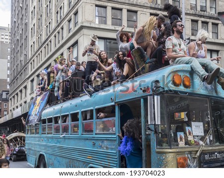 New York, NY, USA - May 17, 2014: Blue Bird bus with members of Blue Byrds dance group drive at The 8th Annual New York City Dance Parade and Festival