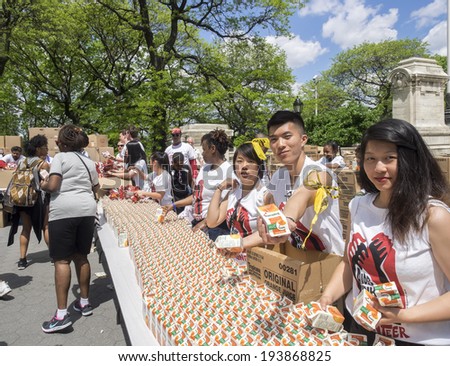 New York, NY, USA - May 18, 2014: Volunteers give away juice and snack to the people participating to the AIDS Walk New York 2014 on Riverside Drive, Manhattan