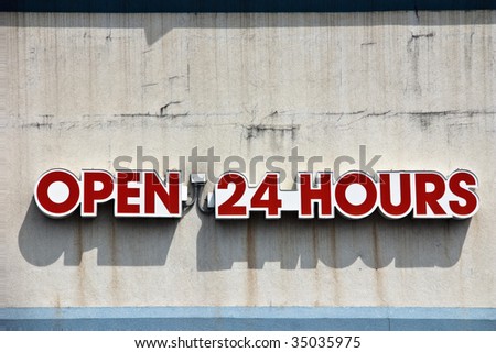 Open 24 hours sign on the grunge cement wall