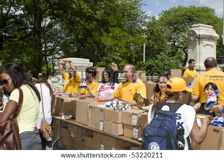 NEW YORK - MAY 16: Volunteers given away snacks to the people participating to the AIDS Walk 2010 on Riverside Drive on May 16, 2010 in New York City.