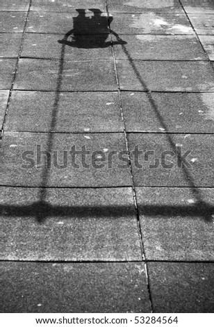 Shadow of the little girl on the swing. Black and White.